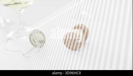 Resting two speckled champagne corks right on white table, with muselet and cap, diagonal stripes Stock Photo