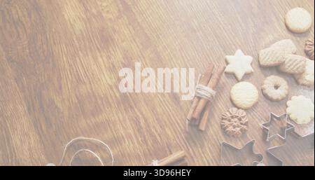 Styling star, round cookies with metal cutters, cinnamon sticks, twine on wood table, copy space Stock Photo