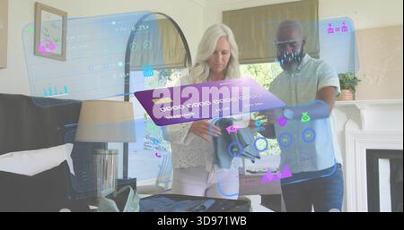 Packing senior couple packing suitcase in white blouse and light shirt using AR UI at home Stock Photo