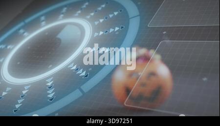 Showing circular HUD glowing with rings and spinning arrows in virtual grid with carved pumpkin Stock Photo