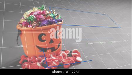 Displaying orange jack-o'-lantern bucket holding foil candies on gray tabletop with blue guides Stock Photo