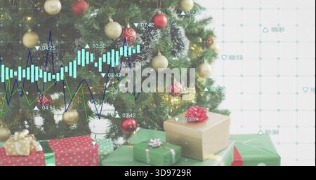 Showing evergreen tree at home with red gold baubles, tinsel, snow, wrapped gifts and candlesticks Stock Photo