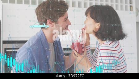 Sharing couple sipping smoothie from jar in kitchen, striped top, striped straws, data overlay Stock Photo