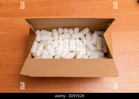 Shipping cardboard box with foam cubes, gift package. Top view. Stock Photo