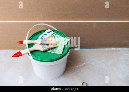 Bucket of paint with a brush on top. Top view. Stock Photo