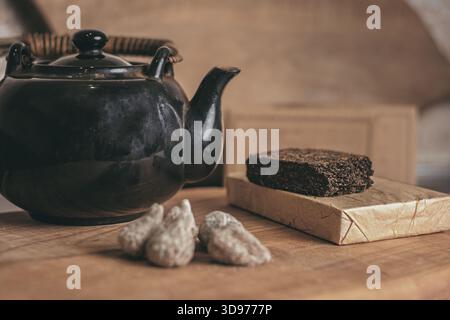 Traditional Chinese tea brewing in an old-style clay teapot placed on a natural cherry-wood board, with subtle steam, refined textures, and an elegant Stock Photo