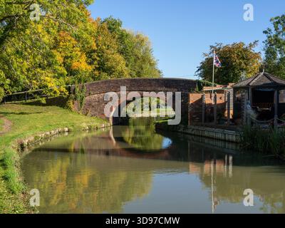 Tranquil autumn scene on the Grand Union canal at Blisworth Arm, Northamptonshire, UK with Bridge No 2 reflected in the calm canal waters Stock Photo