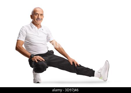 Mature man in sportswear stretching leg isolated on white background Stock Photo