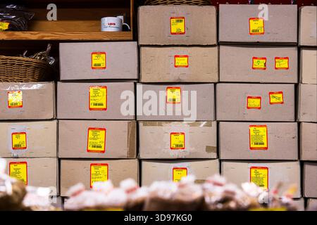 Wuerzburg, Germany, December 22nd, 2024. A wall of cardboard boxes with spices, herbs, and seasonings, stacked in rows. Storage or inventory at a chri Stock Photo