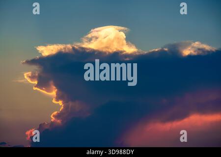 Dramatic vibrant clouds formation on blue sky in the sunset Stock Photo