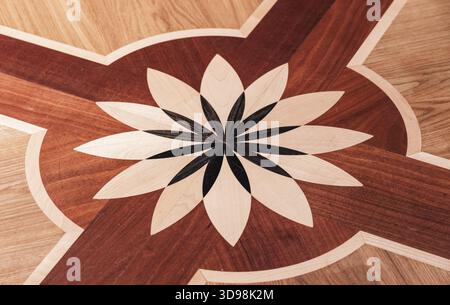 Flower design element of wooden parquet with different wood types, abstract geometric pattern on the floor of classical interior. Architecture backgro Stock Photo