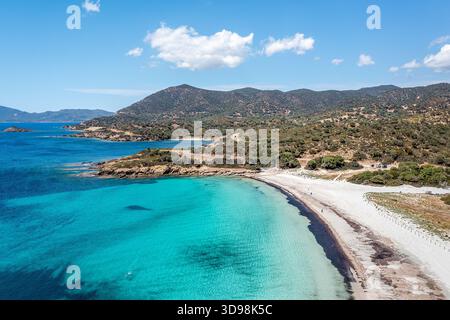A vivid aerial view of a tropical beach featuring bright turquoise water, soft white sand, and a rugged coastline, Sardinia, Italy Stock Photo