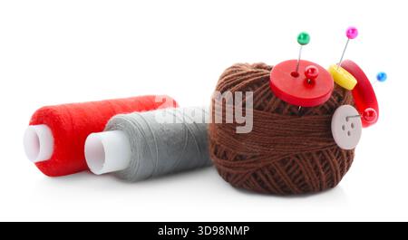 Ball of bright knitting yarn with buttons, spools of thread and pins isolated on white Stock Photo