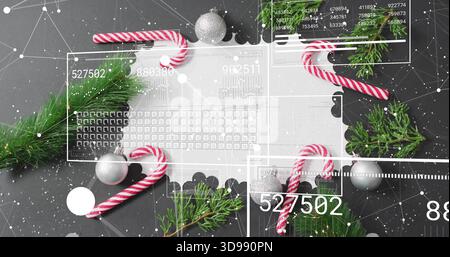 Displaying scalloped doily with candy canes, evergreen sprigs, silver baubles, HUD overlay on table Stock Photo
