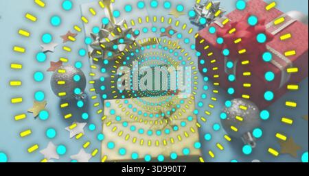 Showing festive scene with turquoise-dot spiral yellow dashes on pale blue, red gift, silver bauble Stock Photo