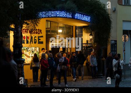Vienna, Austria - October 5, 2025 - People gathered at the entrance of Hundertwasser Village at night. Stock Photo
