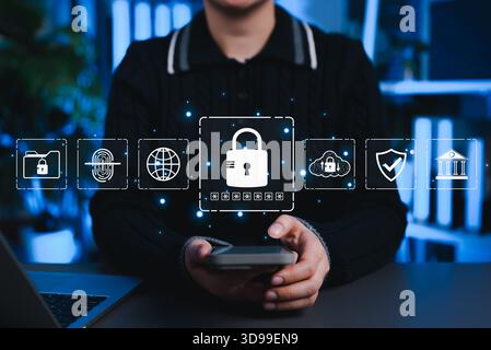 Cybersecurity and data protection concept with user holding smartphone and digital lock icons, representing secure access, encryption, privacy, cloud Stock Photo