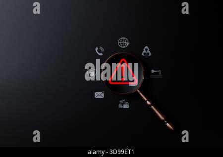 Cybersecurity threat detection concept. Magnifying glass on red alert symbol representing online risk, data breach, malware warning, scam, phishing, Stock Photo