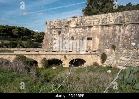 Route of the old and abandoned Maltese railway line with bricked up tunnel. Stock Photo
