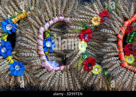 Ukrainian traditional wreaths from ears of wheat and flowers on a street market for sale to tourists in Kyiv, Ukraine. Close up Stock Photo