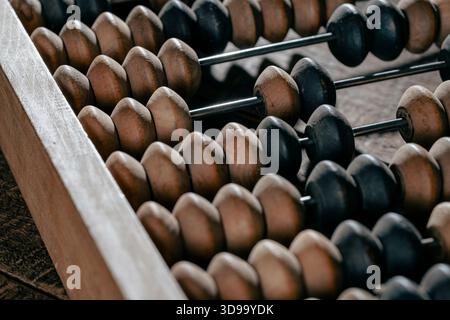 Vintage wooden abacus lying on the wooden table background, close up Stock Photo