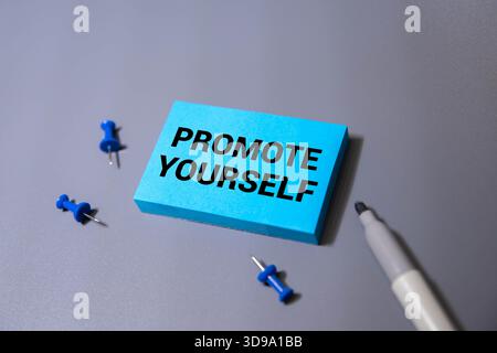 PROMOTE YOURSELF text written on a notebook with chart. Stock Photo