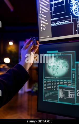 Rogue software developer penetrating firewalls using data theft script on USB stick. Close up of hacker doing covert operations, bypassing security using phishing software on thumb drive Stock Photo