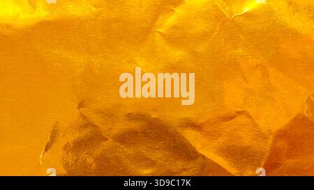 Vibrant Crumpled Gold Foil Texture Background with Wrinkles and Folds for Luxury Celebration and Abstract Design Stock Photo