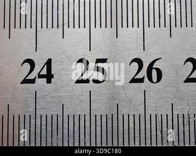 Extreme Close-up of Silver Brushed Metal Ruler or Measuring Tape Showing Metric Numbers for Precision and Engineering Stock Photo