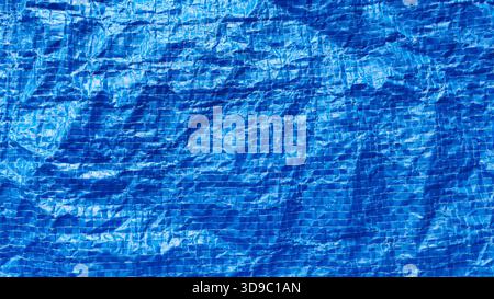 Bright Blue Woven Plastic Shopping Bag Texture Background with Wrinkled Crinkled Surface and Visible Grid Lines for Recycle Concept Stock Photo