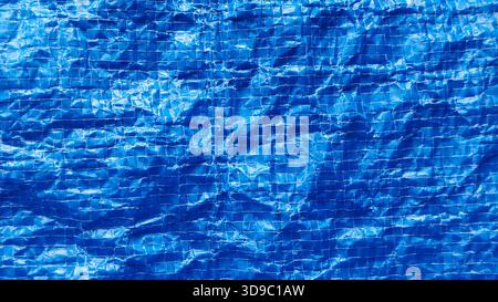 Bright Blue Woven Plastic Shopping Bag Texture Background with Wrinkled Crinkled Surface and Visible Grid Lines for Recycle Concept Stock Photo