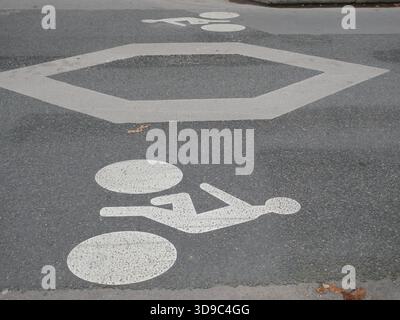 Dedicated bicycle lane pictograms painted on asphalt street surface Stock Photo