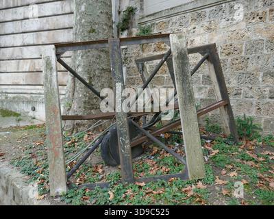 Abandoned work site equipment with old wheel and frames Stock Photo