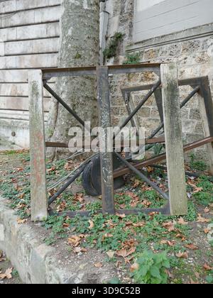 Abandoned work site equipment with old wheel and frames vertical photo Stock Photo