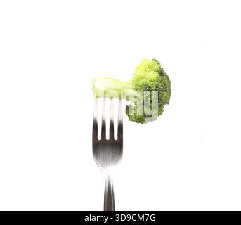 Broccoli impaled on a fork. White background Stock Photo