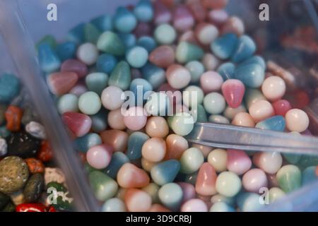 Colorful background of mixed pastel gemstones. round polished stones create beautiful texture for any craft or hobby project. playful and calming coll Stock Photo