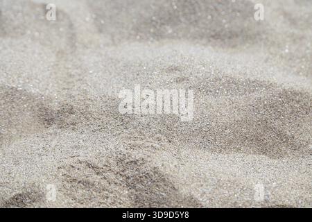 Sand background. Uneven gray sand close up Stock Photo