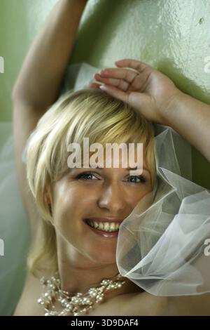 Beautiful smiles of the bride of the blonde. The happy Bride Stock Photo