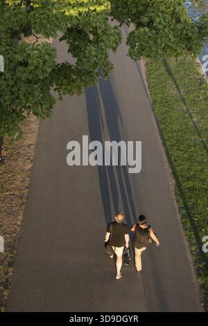 Aerial view of people walking and casting long shadows on the sandbar ...
