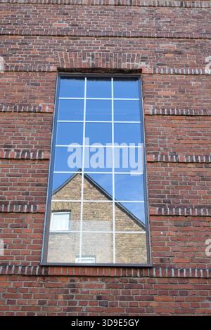modern window in an old red brick building Stock Photo