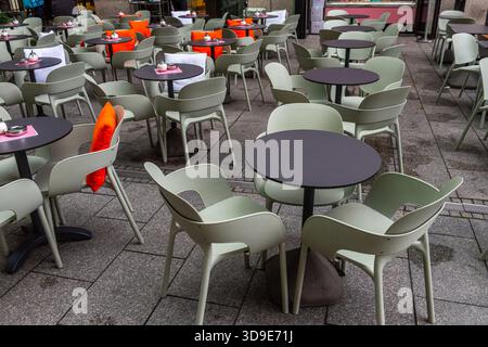 Tables and chairs outdoors in a street restaurant or cafe in Germany Stock Photo
