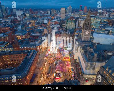 Aerial view of Manchester’s Albert Square with the Christmas markets, bright festive wheel and Town Hall tower at dusk. Stock Photo