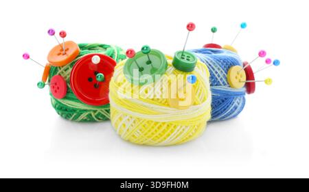 Balls of bright knitting yarn with buttons and pins isolated on white Stock Photo