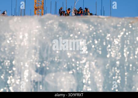Harbin, China's Heilongjiang Province. 5th Dec, 2025. Workers are seen at the construction site of Ice and Snow World in Harbin, northeast China's Heilongjiang Province, Dec. 5, 2025. The 27th edition of Ice and Snow World in Harbin has recently kicked off its construction work, which involves more than 10,000 workers and about 1,000 machines. The park area is expected to be extended to 1.2 million square meters, the largest of all editions in history. Credit: Zhang Tao/Xinhua/Alamy Live News Stock Photo