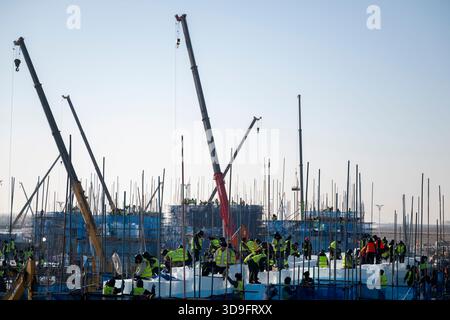 Harbin, China's Heilongjiang Province. 5th Dec, 2025. Workers are seen at the construction site of Ice and Snow World in Harbin, northeast China's Heilongjiang Province, Dec. 5, 2025. The 27th edition of Ice and Snow World in Harbin has recently kicked off its construction work, which involves more than 10,000 workers and about 1,000 machines. The park area is expected to be extended to 1.2 million square meters, the largest of all editions in history. Credit: Zhang Tao/Xinhua/Alamy Live News Stock Photo