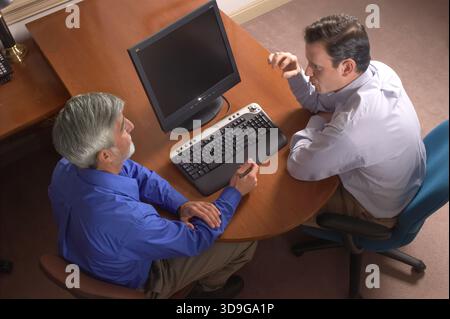 Overhead view of two businessmen talking in meeting room, New York, USA Stock Photo