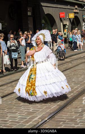 Samba dancer in white costume on Aleksanterinkatu at Helsinki Samba Carnaval in Kluuvi district of Helsinki, Finland Stock Photo
