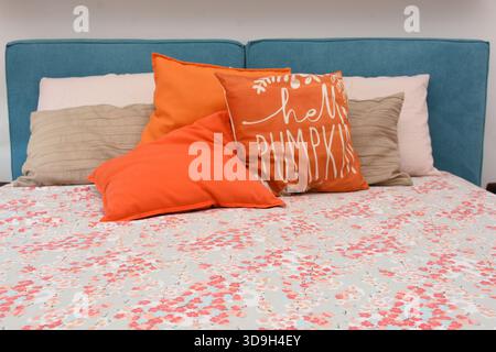 cushions representing autumn placed on the bed Stock Photo