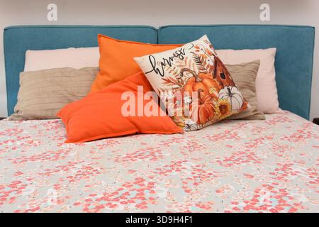 cushions representing autumn placed on the bed Stock Photo