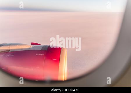 View from airplane's window above clouds during sunset Stock Photo